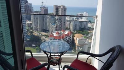 Cozy balcony with sea view, glass table and two chairs