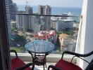 Cozy balcony with sea view, glass table and two chairs