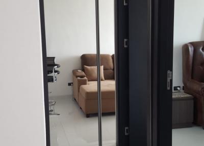 View into a modern living room through a sliding glass door