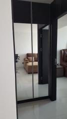 View into a modern living room through a sliding glass door