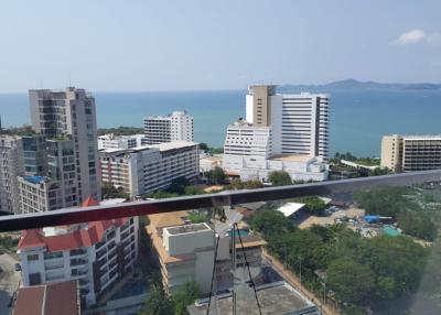 Panoramic aerial view of a coastal city from a high-rise balcony