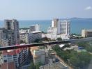 Panoramic aerial view of a coastal city from a high-rise balcony