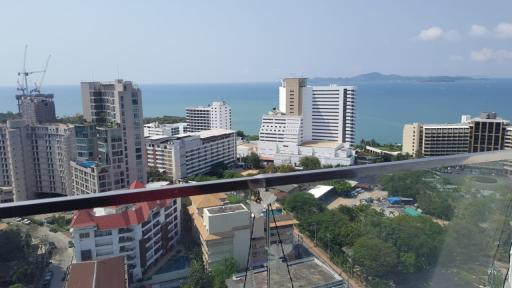 Panoramic aerial view of a coastal city from a high-rise balcony