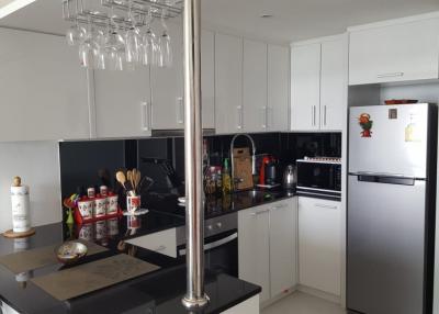 Modern kitchen with stainless steel appliances and white cabinetry