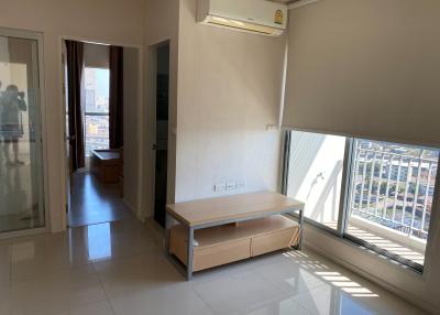 Spacious living room with natural light and balcony access