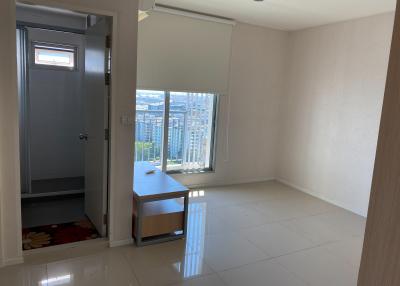 Empty bedroom with large window and city view