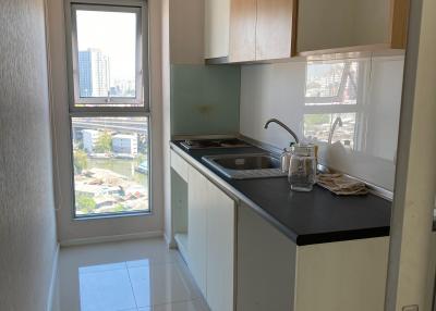 Compact kitchen space with a view of the city