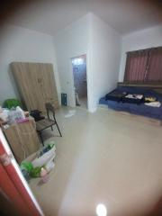 Bedroom with basic furniture and tiled flooring