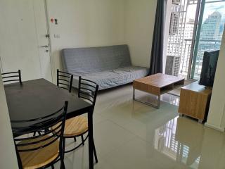 Modern living room with dining table and convertible sofa bed with city view