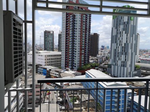 City view from the balcony of a high-rise apartment complex