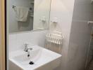 Modern minimalist bathroom with white ceramic sink and wall-mounted mirror