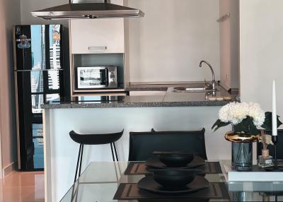 Modern kitchen with stainless steel appliances and breakfast bar