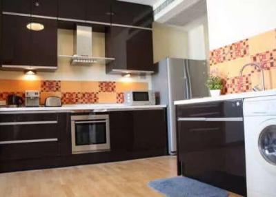 Modern kitchen with integrated appliances and tiled backsplash