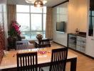 Modern living room with dining area and city view