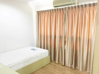 Bright and clean bedroom with a single bed and air conditioning unit