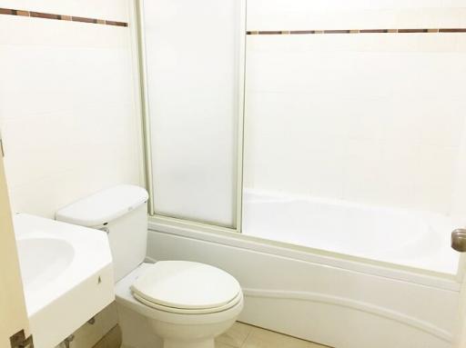 Clean and simple bathroom with toilet and tub