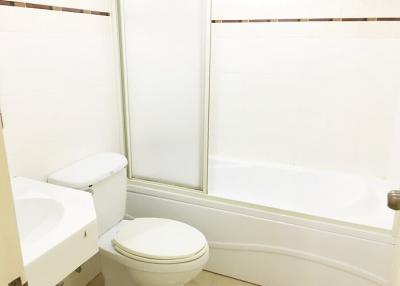 Clean and simple bathroom with toilet and tub