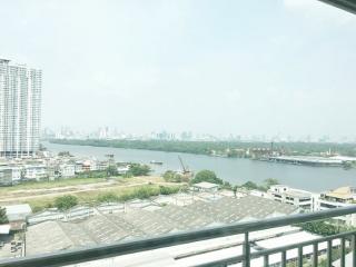 Expansive city view from apartment balcony overlooking a river