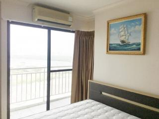 Bedroom interior with ocean view and balcony access