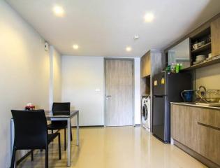 Compact modern kitchen with appliances and a dining area