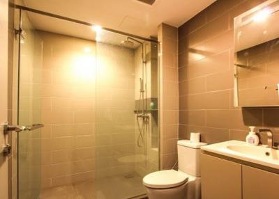 Modern bathroom with glass shower and well-lit vanity area