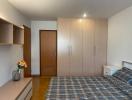 Cozy bedroom with large wardrobe and wooden finishes