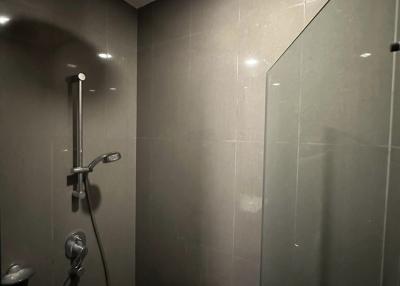 Modern bathroom with walk-in shower and gray tiles