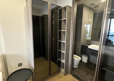 Bedroom interior with adjacent bathroom visible through open door