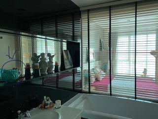 Contemporary bathroom with large mirror and window blinds
