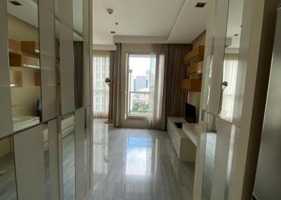 Bright and spacious hallway with floor-to-ceiling mirrors and tiled flooring