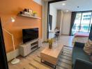 Cozy and modernly furnished living room with warm orange walls and ample natural light