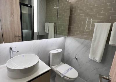Modern bathroom with beige tiles and sleek fixtures