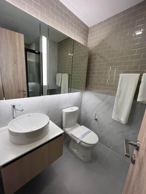 Modern bathroom with beige tiles and sleek fixtures