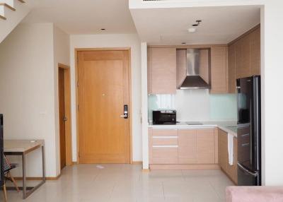 Modern kitchen with wood cabinets and stainless steel appliances