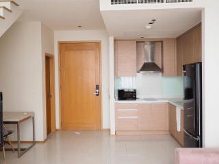 Modern kitchen with wood cabinets and stainless steel appliances