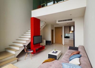 Modern living room interior with a red staircase and mezzanine