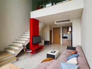 Modern living room interior with a red staircase and mezzanine