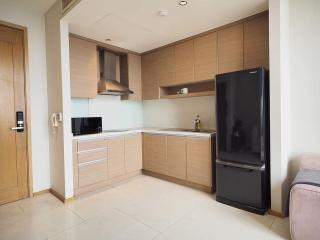 Modern kitchen with wooden cabinets and stainless steel appliances