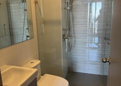 Modern bathroom with walk-in shower and white fixtures