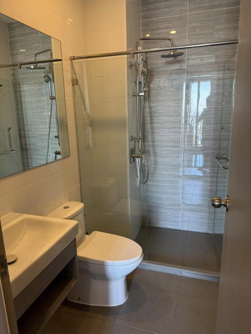 Modern bathroom with walk-in shower and white fixtures