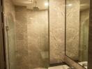 Modern bathroom with beige tiles and glass shower