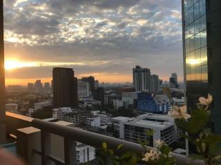 Stunning city skyline view at sunset from high-rise apartment balcony