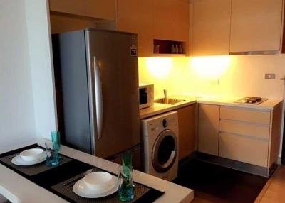 Modern kitchen with stainless steel appliances and dining area