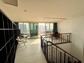 Spacious living room with natural light and city view