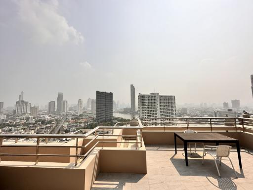 Spacious terrace with city skyline view and outdoor furniture