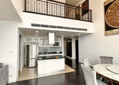 Modern open concept living space with kitchen, high ceiling, and mezzanine