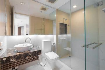 Modern bathroom with glass shower and marble countertops