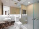 Modern bathroom with glass shower and marble countertops