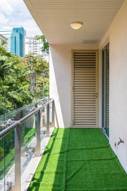 Modern balcony with artificial grass overlooking cityscape