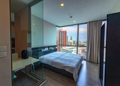 Modern bedroom with city view and ample natural light